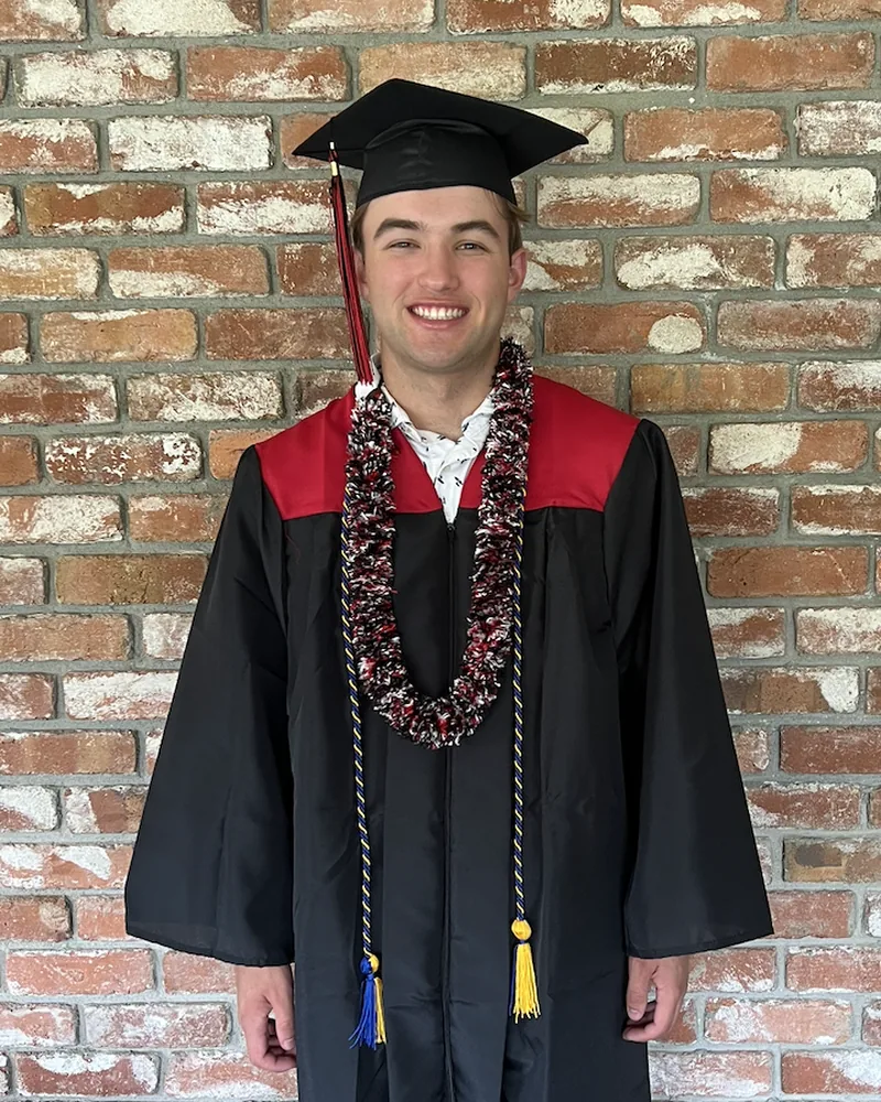 Me in my cap and gown at high school graduation