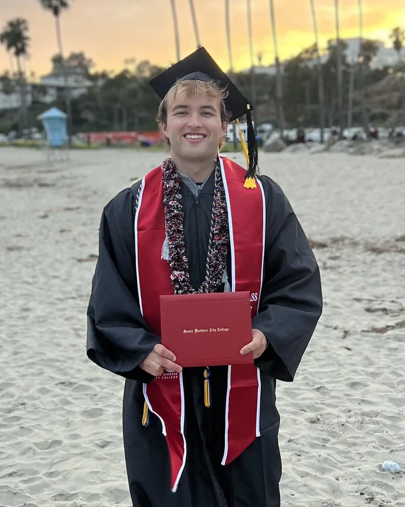 Me on the beach at sunset, holding my Santa Barbara City College diploma